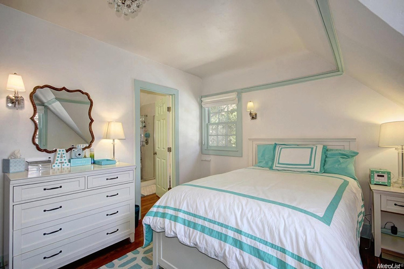 After: White and teal give the room a more grown-up look.