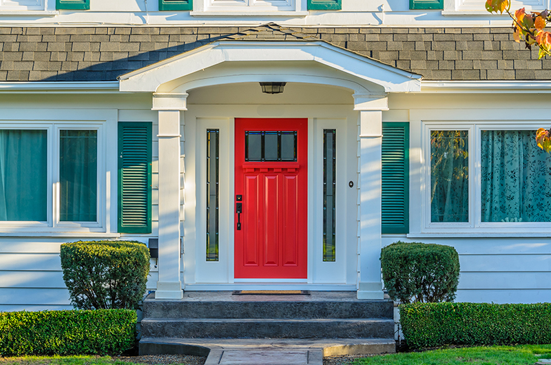 red front door on traditional home