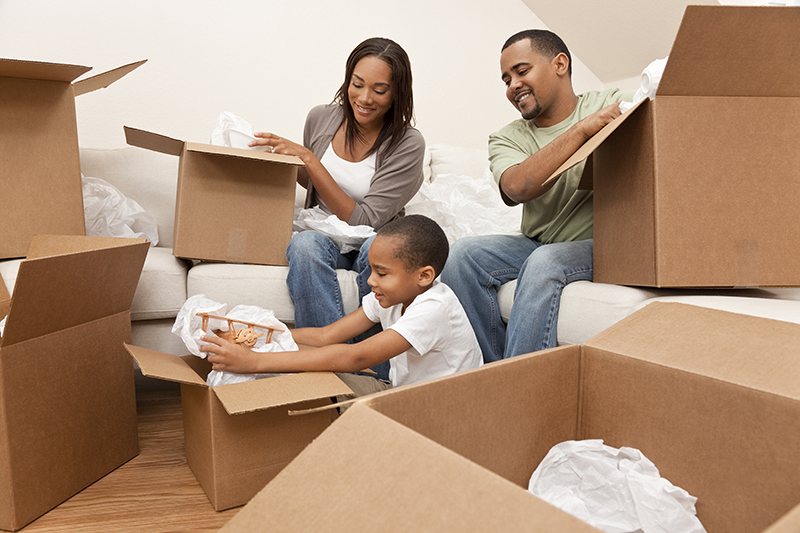 Family unpacking belongings after moving