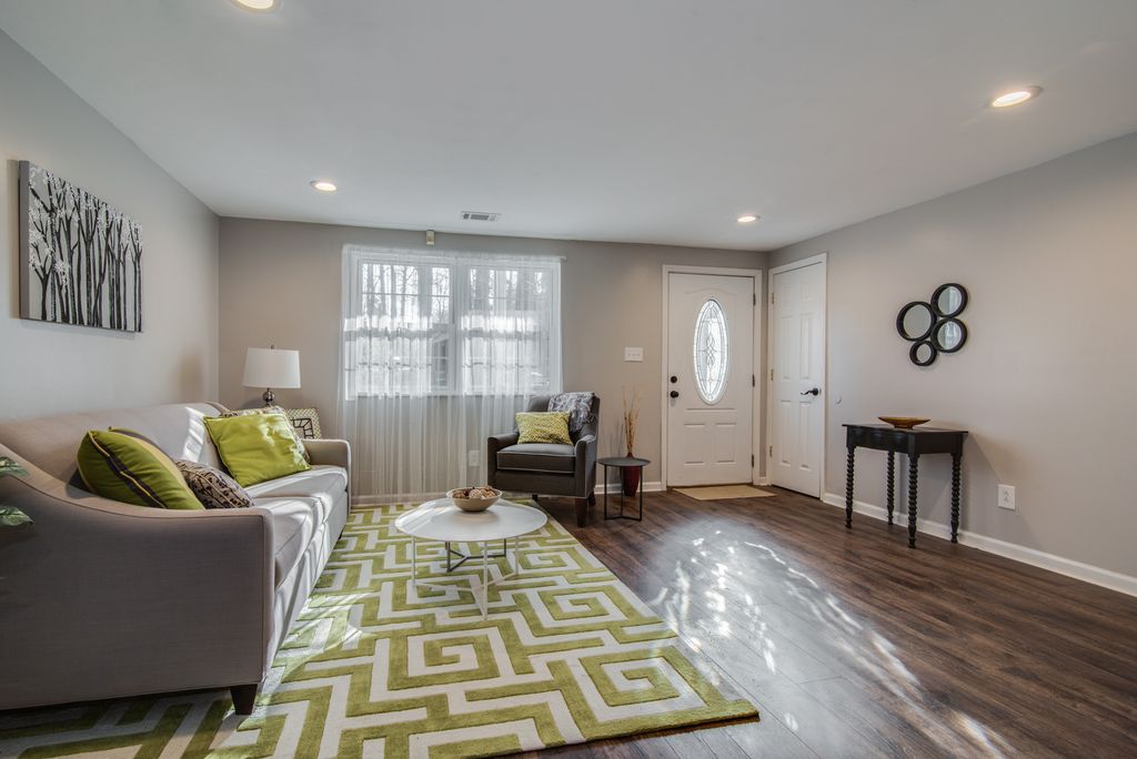 Transitional living room with Greek key patterned area rug. 